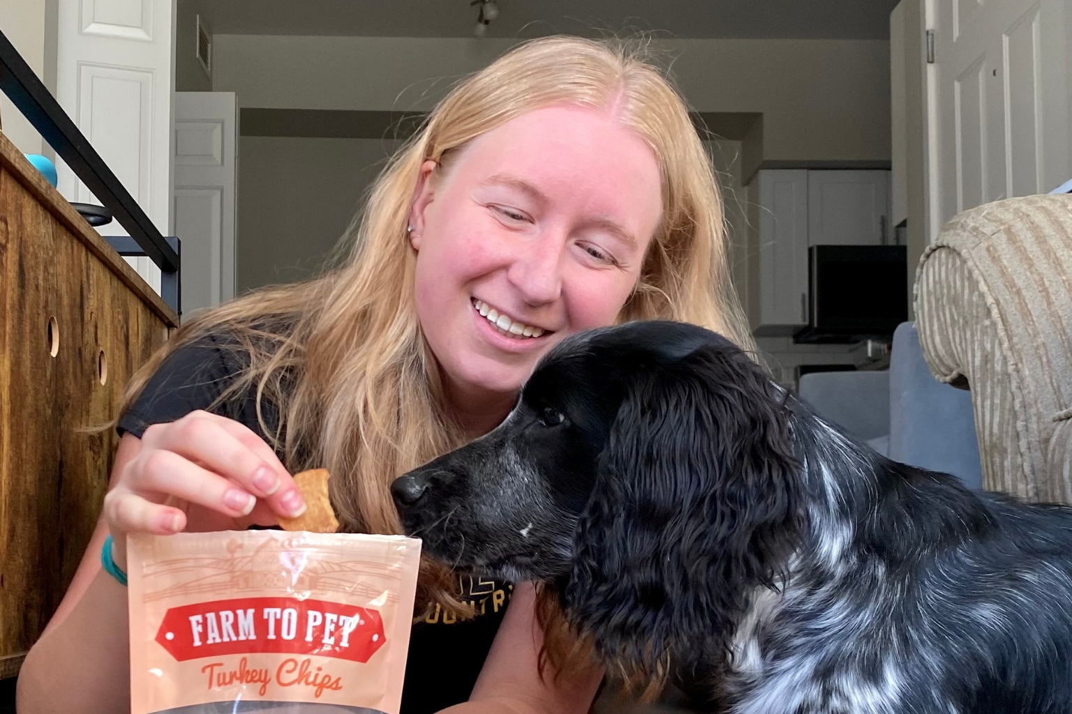 Dog waiting to be fed Farmto-pettreats Turkey Chips from his owner, Sarah.