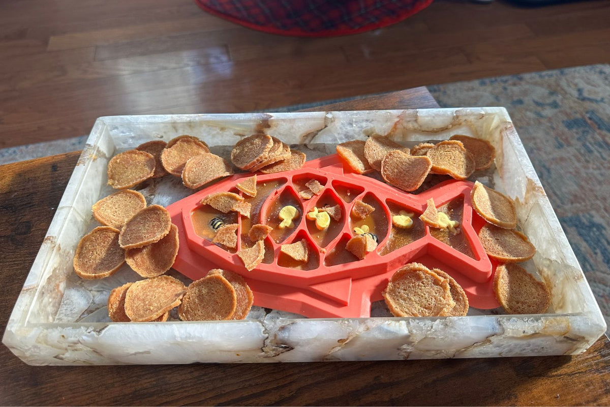 a tray of Farmto-pettreats fish chips dog treats and a fish shaped lick mat