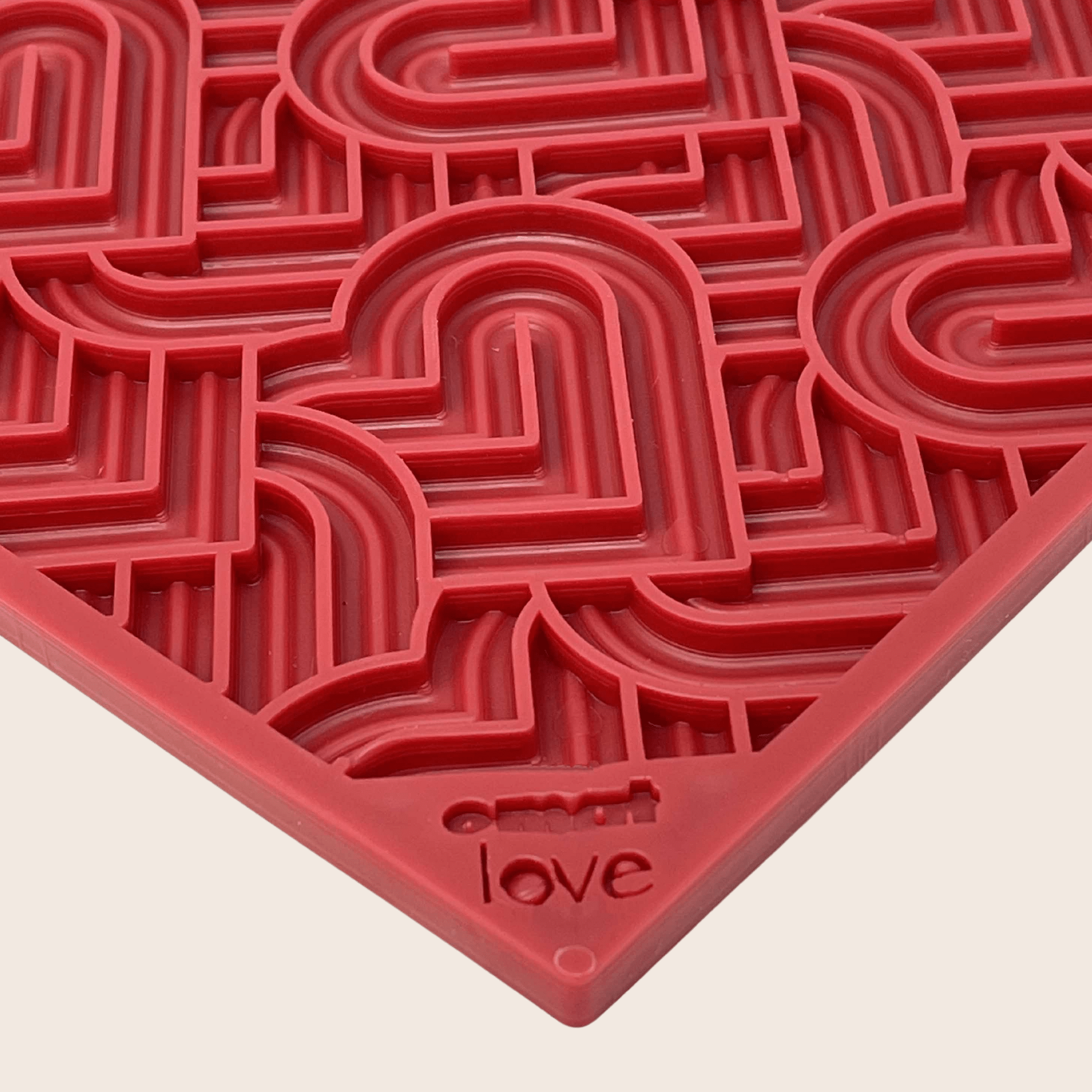 Farmto-pettreats Red Heart lick mat  with 'love' engraved on a beige background.