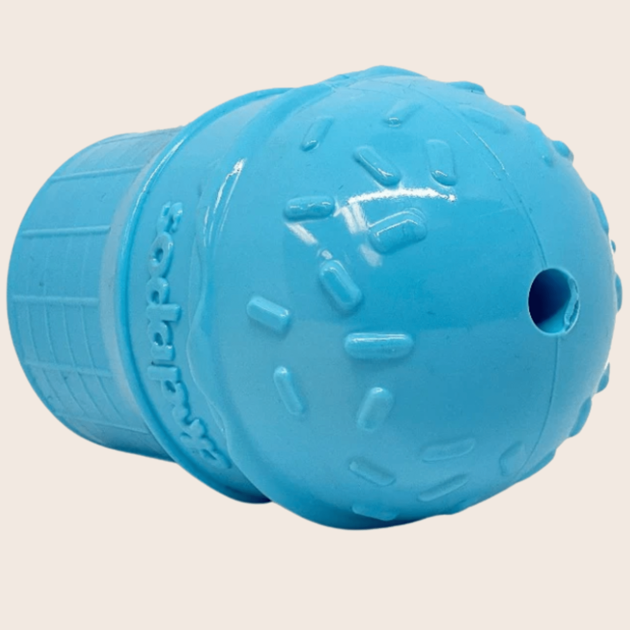 Farmto-pettreats Dog Treat Dispenser Blue  ice cream top view with a hole  on the top on a beige background