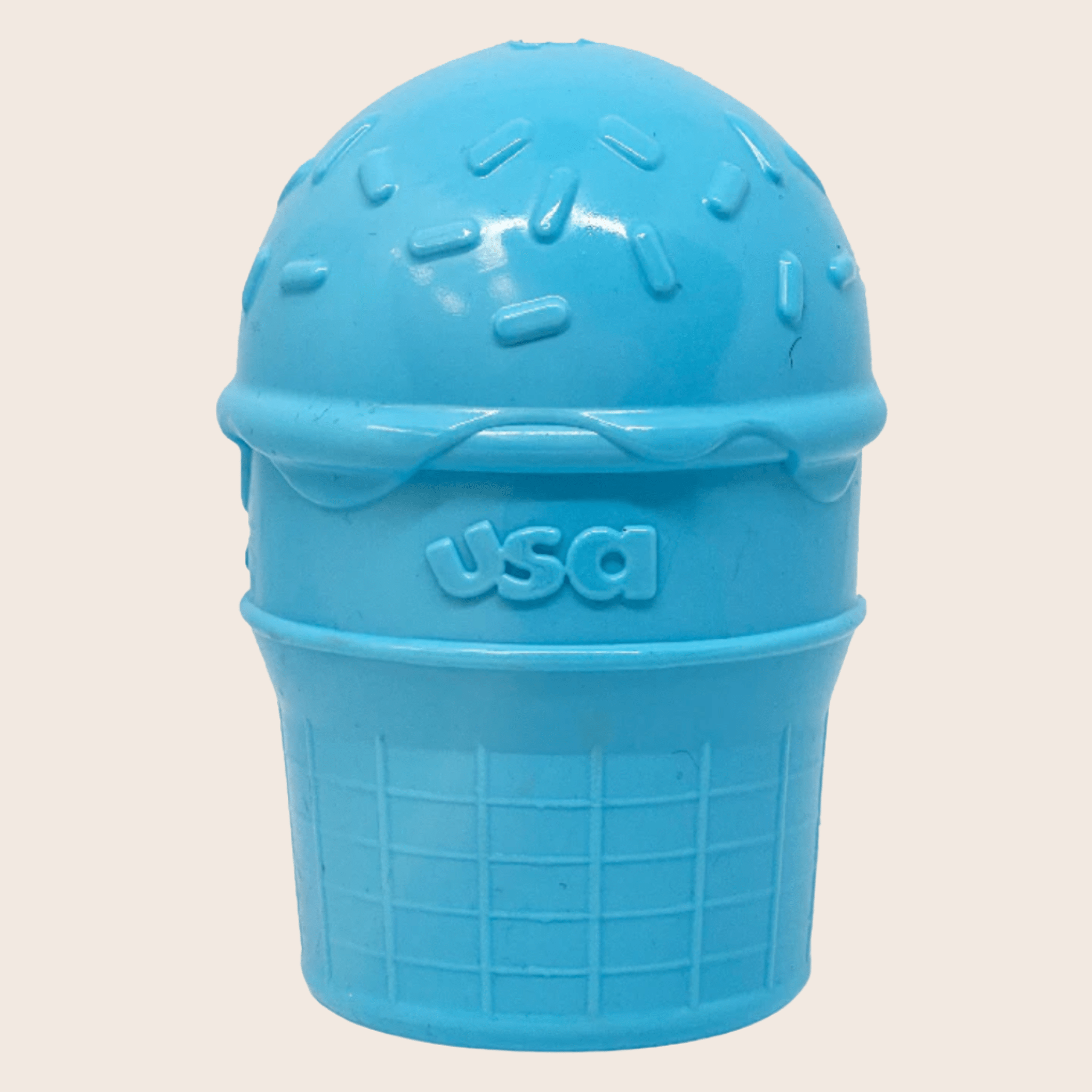 Farmto-pettreats Dog Treat Dispensers blue ice cream container with 'USA' text on a beige background.