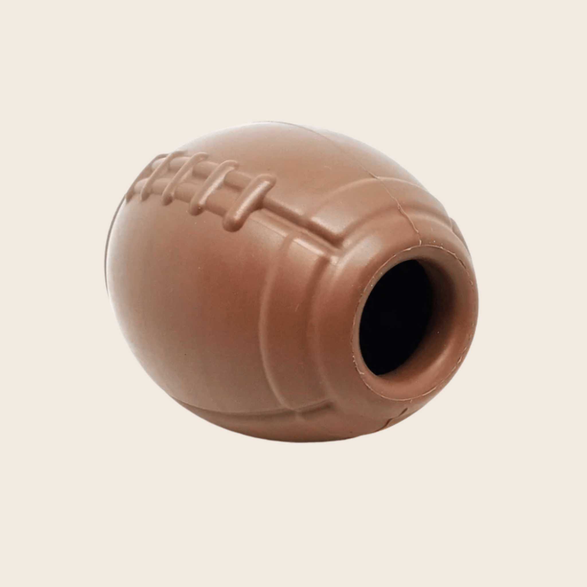 Farmto-pettreats Dog Treat Dispenser Brown football side view on a beige background