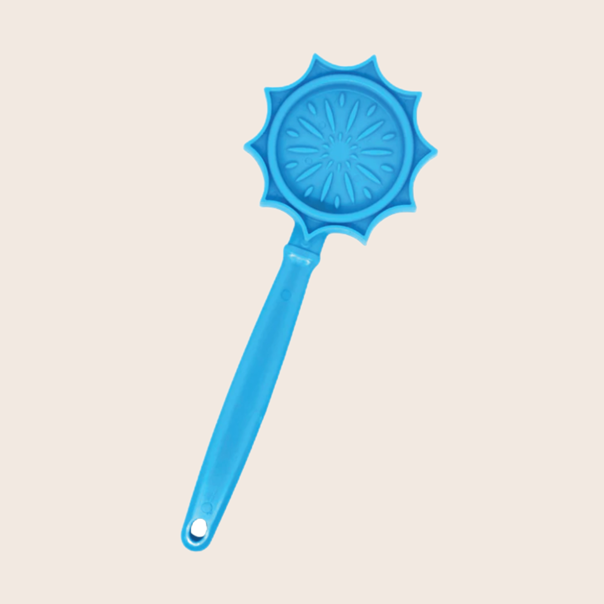 A Farmto-pettreats Lick Stick Blue Flower  with a handle on a beige background.