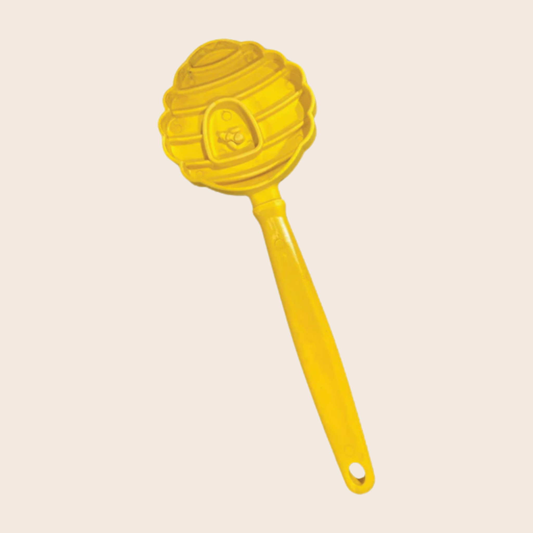 A Farmto-pettreats Lick Stick Yellow Beehive-shaped  on a beige background.