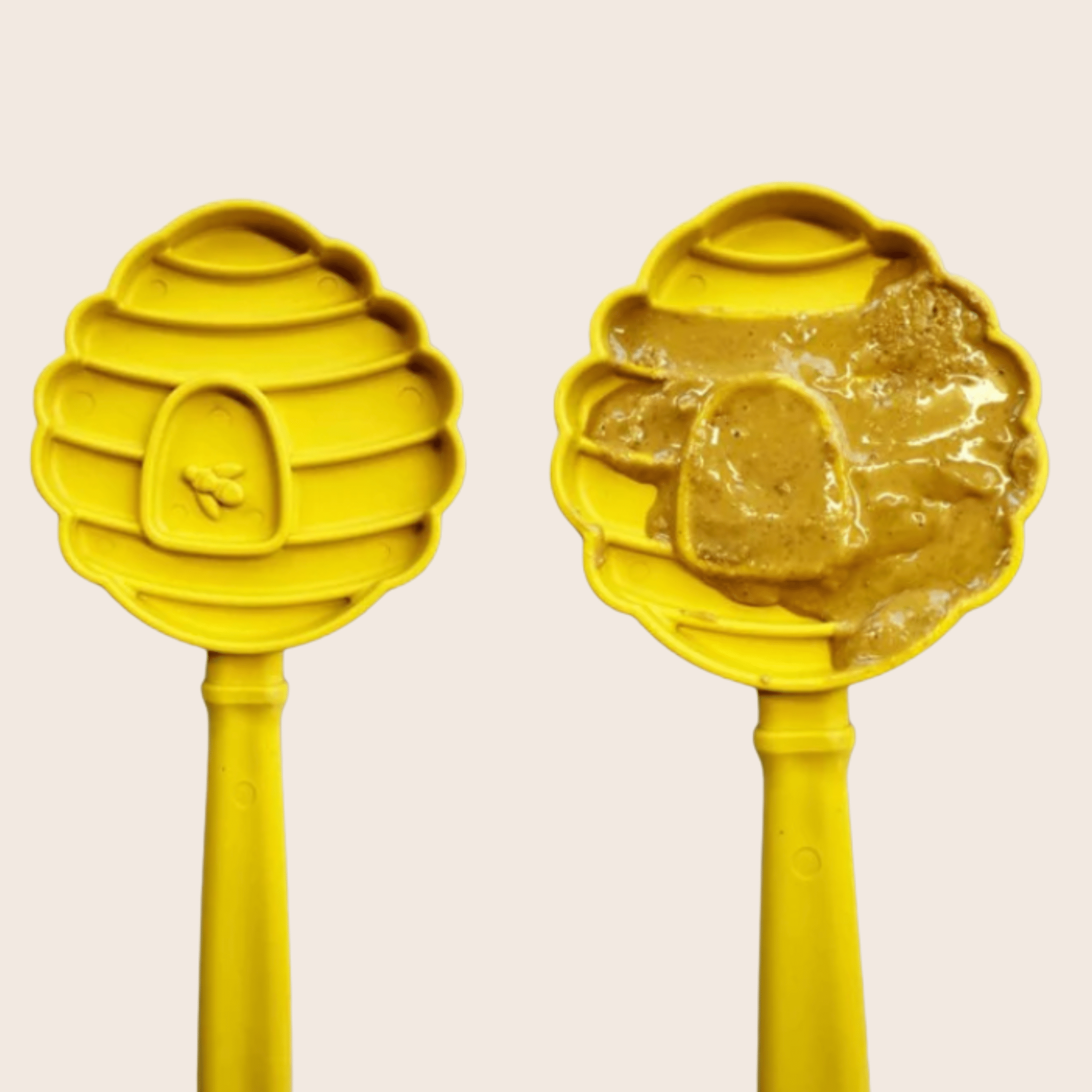 A Farmto-pettreats Lick Stick two yellow beehives one with honey on a beige background.