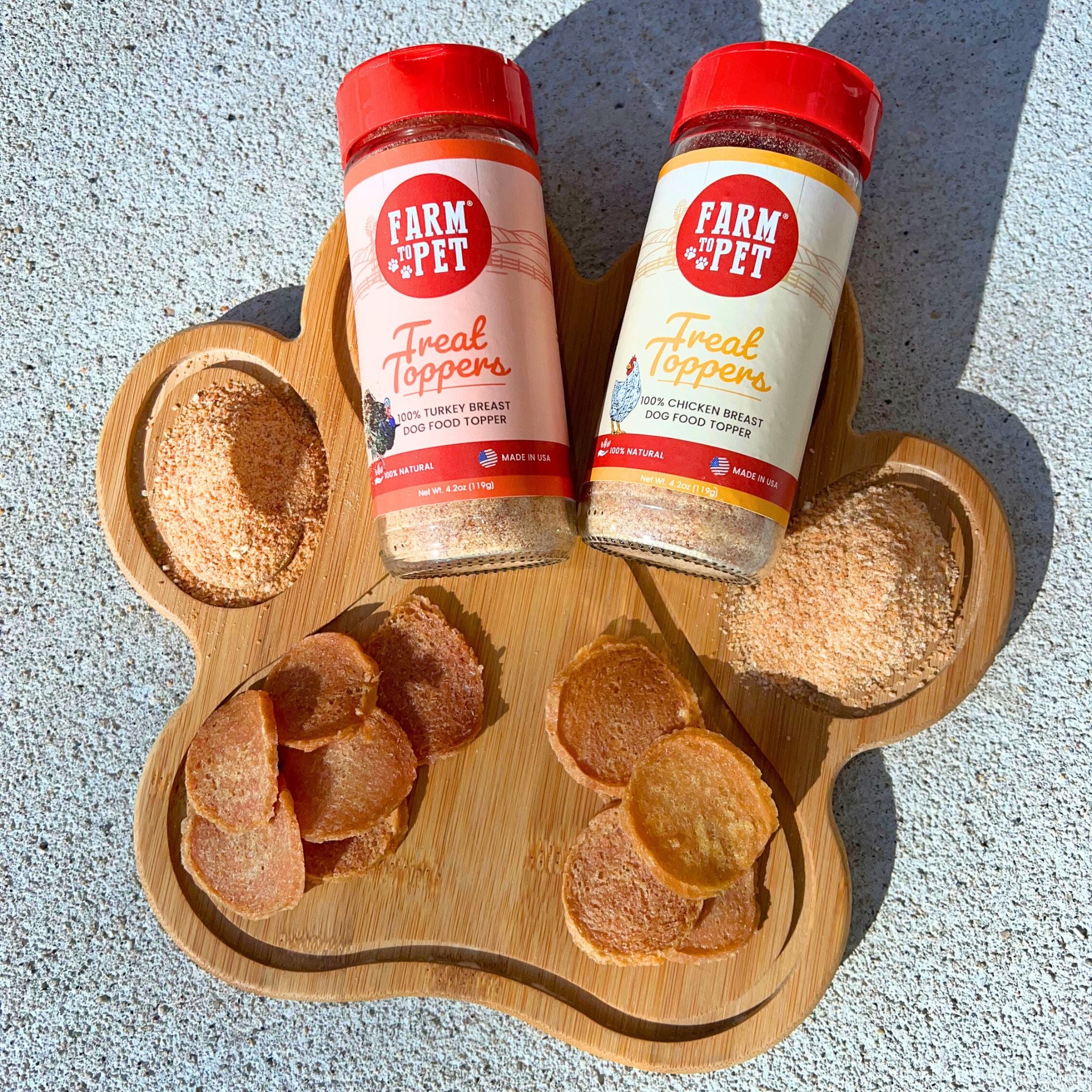 Two gloss jars and a wooden board with chicken chips and sprinkled with Farmto-pettreats chicken and Turkey Combo Topper Pack.