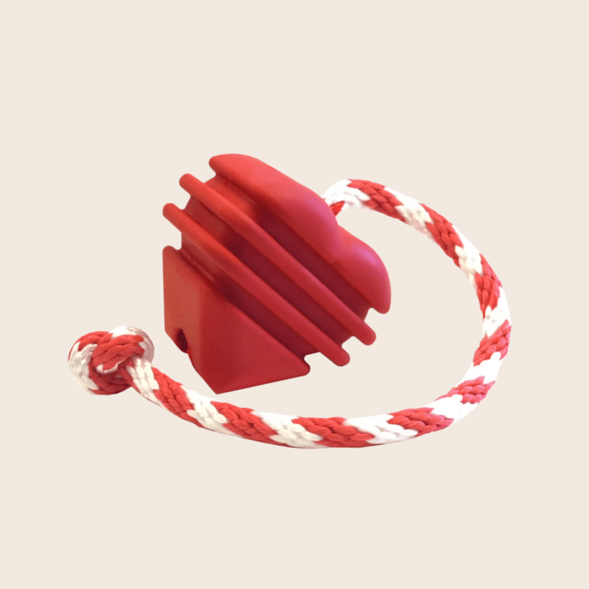 Farmto-pettreats Tug Toy a Red Heart on a String dog tug with a red and white rope on a beige background.