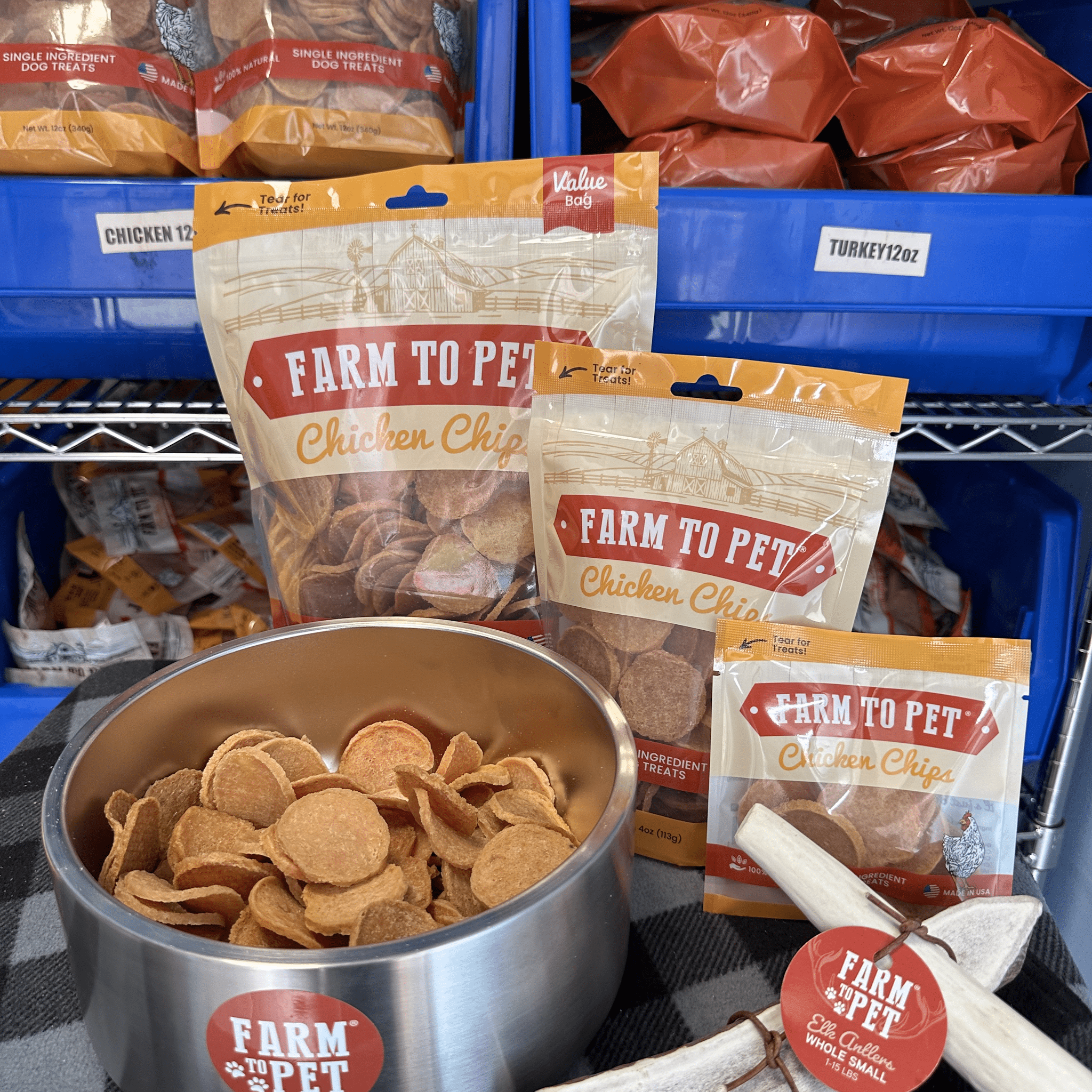 Product picture of Farmto-pettreats Whole Small Elk Antlers 12 oz. and 4oz  bags of Chicken Chips with a metal dog bowl full of chicken chips.