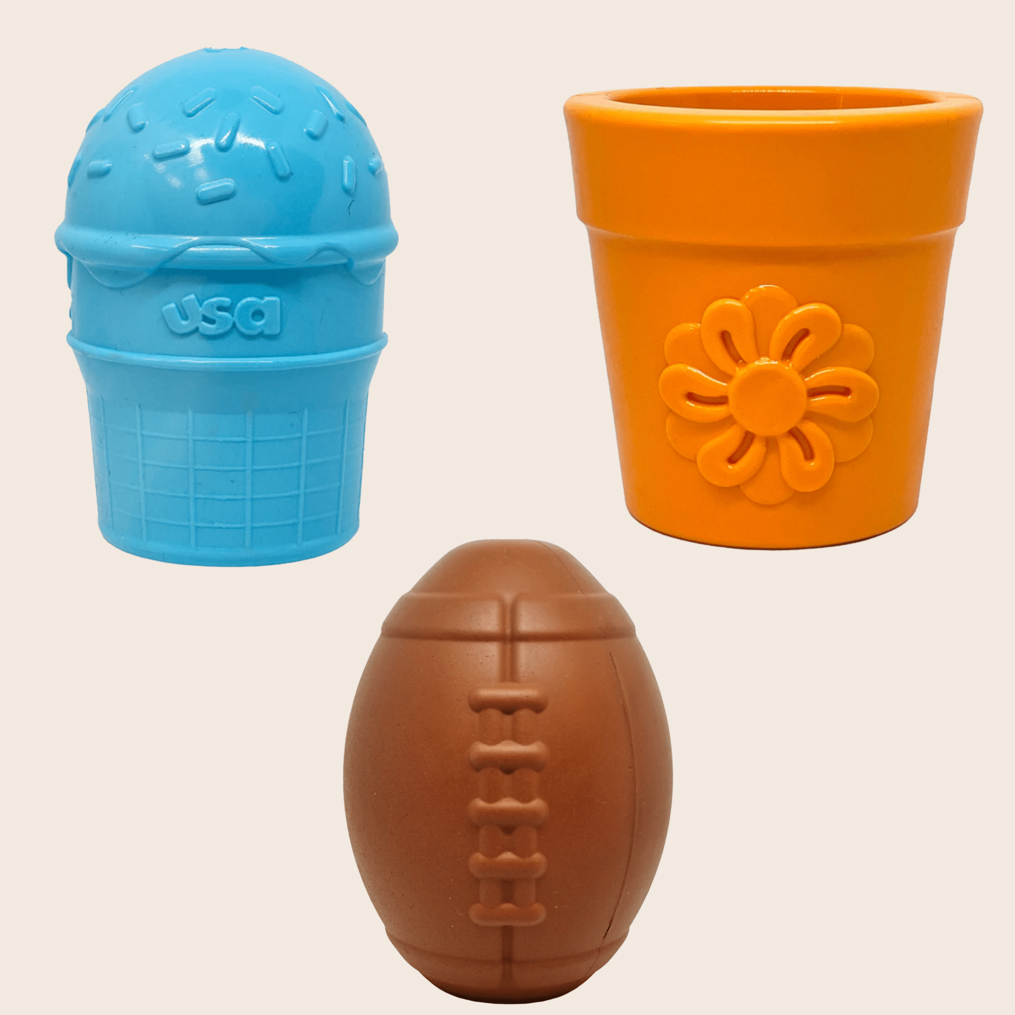 Three colorful Farmto-pettreats Dog Treat Dispensers blue ice cream, orange flower pot and brown football on a beige background
