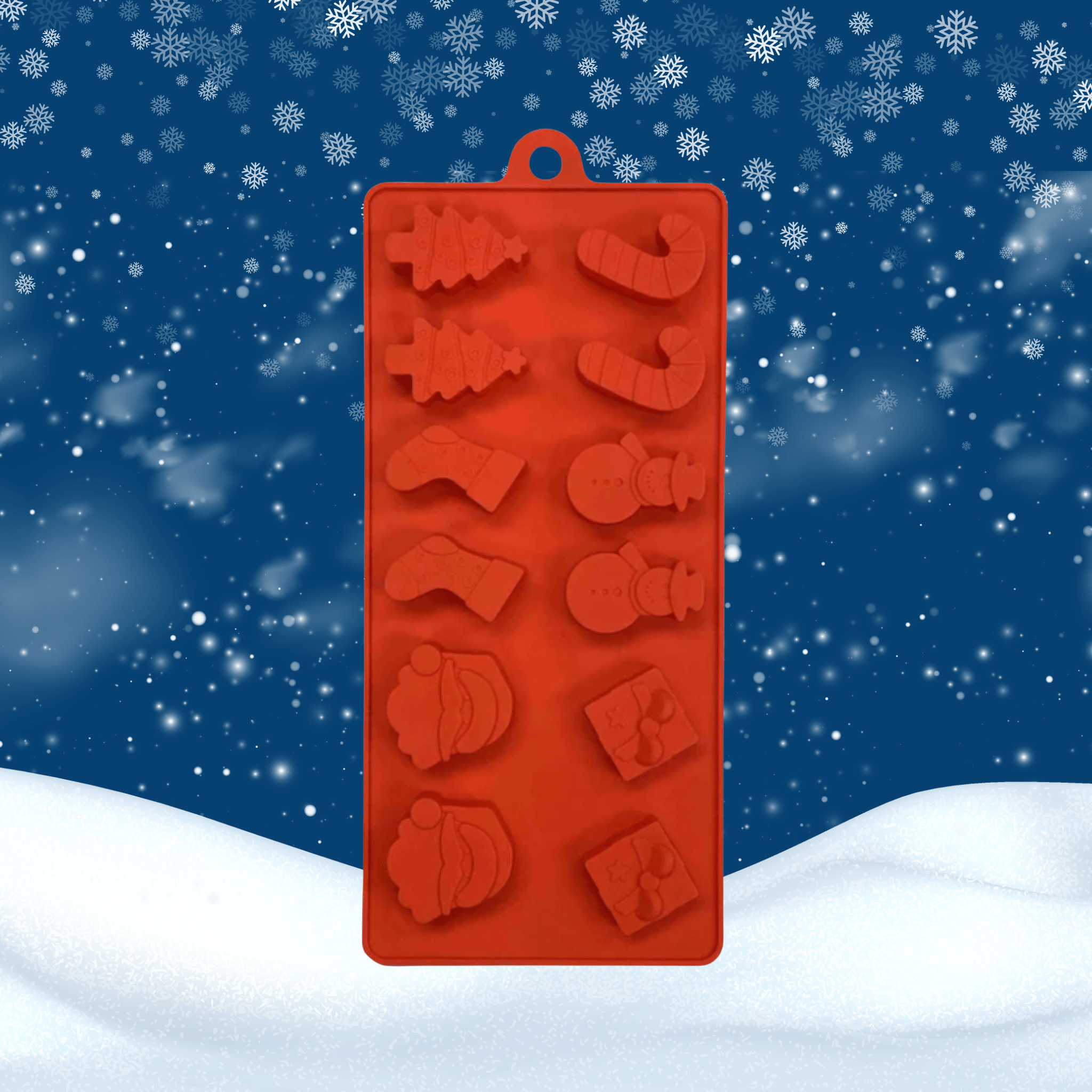 Red silicone mold with Christmas shapes on a snowy background