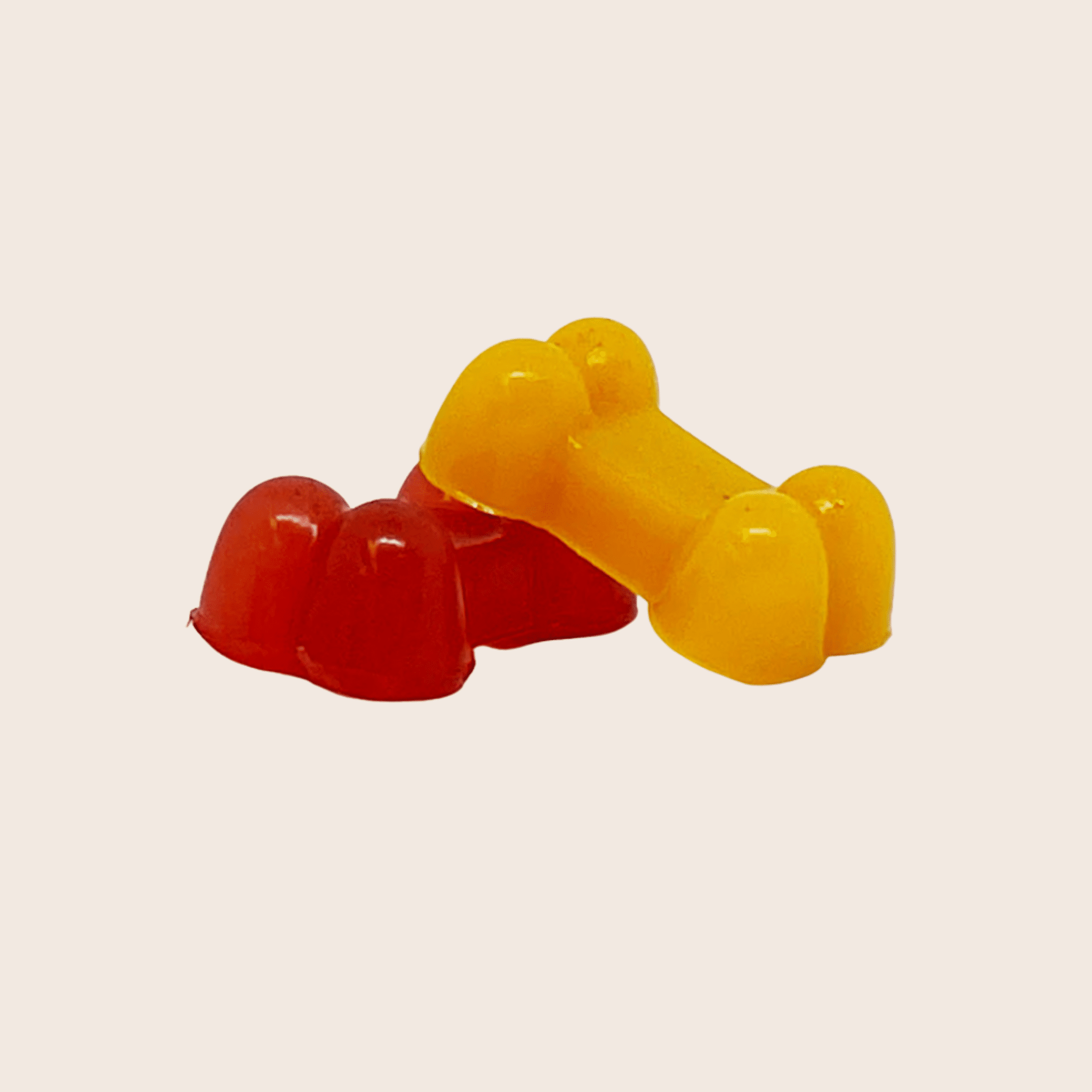 Two bone-shaped treat from silicone mold on a beige background